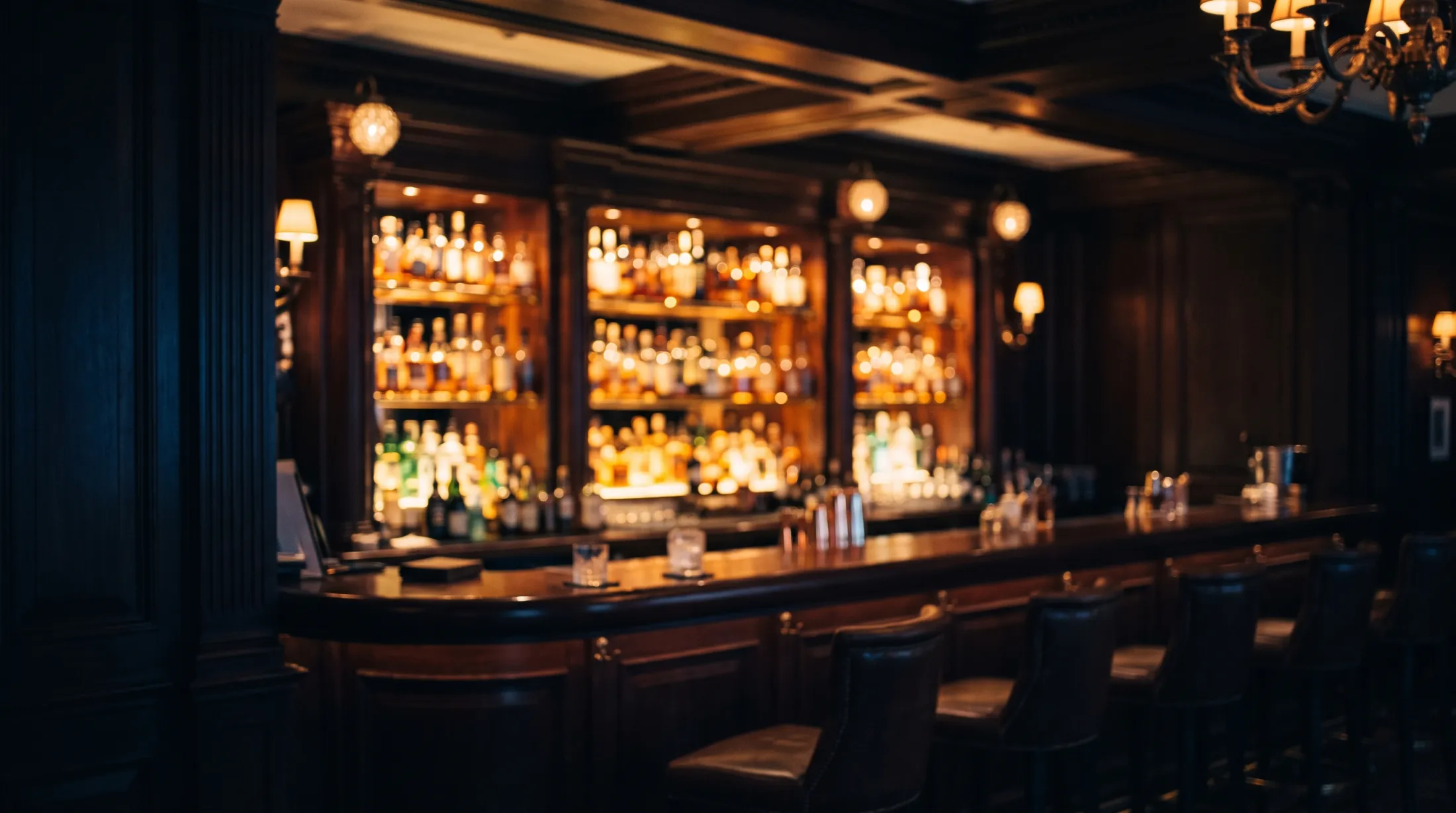 Dimly lit London hotel bar before a private evening engagement.